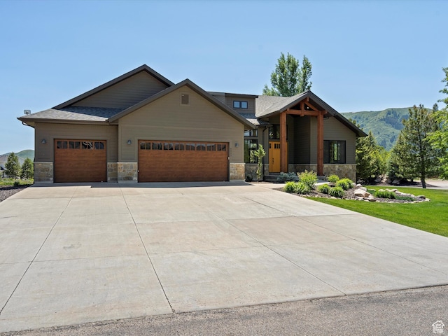 4021 E 4325 N, Eden, UT 84310 - view of front facade featuring stone siding, a garage, and concrete driveway