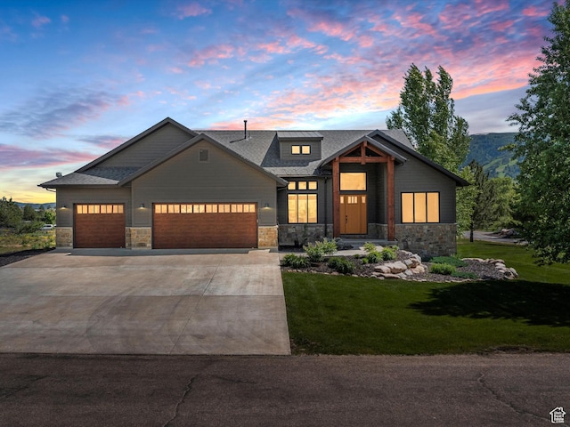 4021 E 4325 N, Eden, UT 84310 - view of front of property featuring stone siding, an attached garage, a front lawn, driveway, and roof with shingles