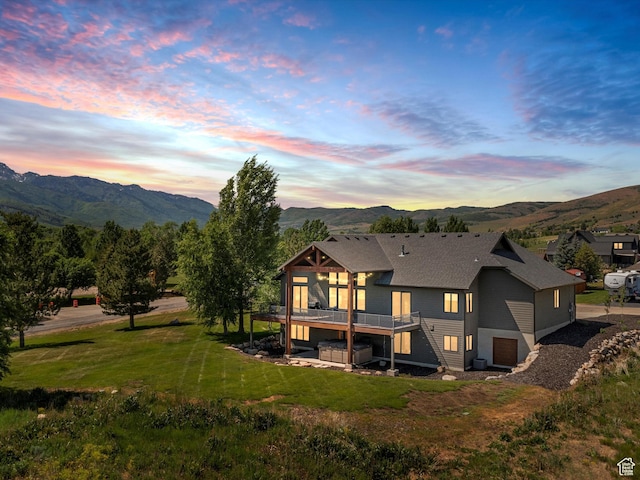 4021 E 4325 N, Eden, UT 84310 - back of property with a deck with mountain view, an attached garage, and a yard
