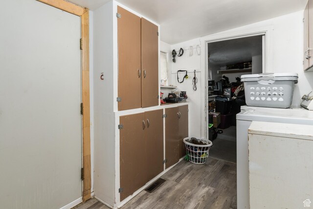 220 S 2nd E, Soda Springs, ID 83276 - laundry area featuring wood finished floors, washer and clothes dryer, and cabinet space