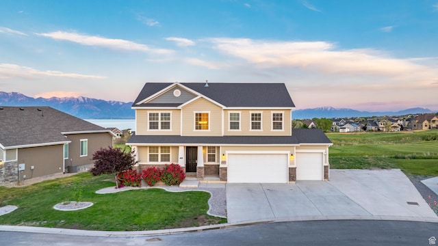 227 E Sandhill Dr, Saratoga Springs, UT 84045 - view of front of home with driveway, a mountain view, a lawn, stone siding, and an attached garage