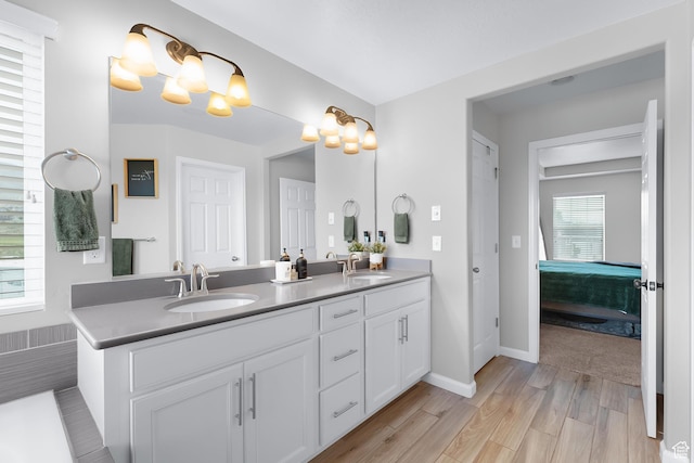 227 E Sandhill Dr, Saratoga Springs, UT 84045 - ensuite bathroom featuring double vanity, wood finished floors, and baseboards