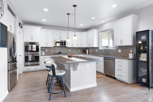 227 E Sandhill Dr, Saratoga Springs, UT 84045 - kitchen with stainless steel appliances, a sink, a kitchen island, tasteful backsplash, and recessed lighting