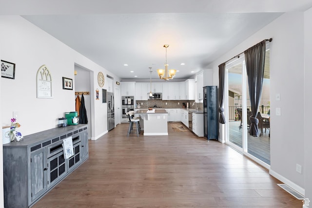 227 E Sandhill Dr, Saratoga Springs, UT 84045 - kitchen featuring stainless steel appliances, a chandelier, a kitchen breakfast bar, a center island, and a sink