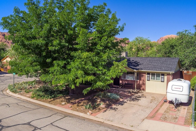 279 Park Rd, Moab, UT 84532 - view of front of property featuring brick siding, roof with shingles, and driveway