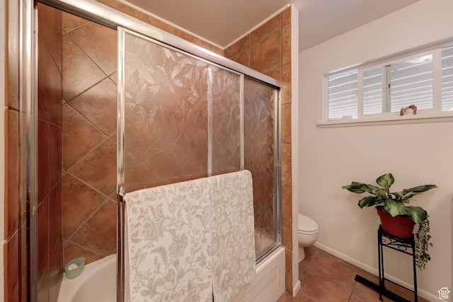 279 Park Rd, Moab, UT 84532 - bathroom featuring toilet, tile patterned floors, combined bath / shower with glass door, and baseboards