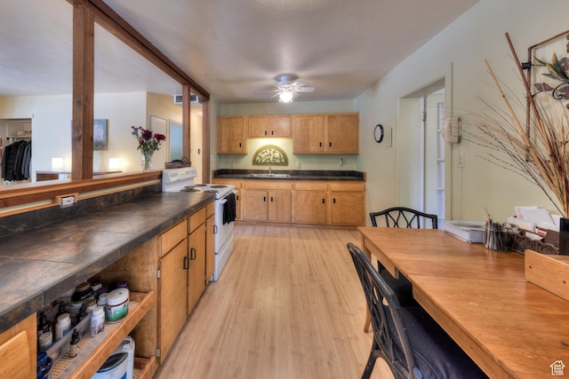 279 Park Rd, Moab, UT 84532 - kitchen with white electric range, dark countertops, light wood-style flooring, and ceiling fan