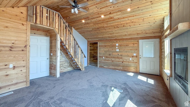 121 2nd W, East Carbon, UT 84520 - unfurnished living room with wooden walls, wooden ceiling, carpet, a ceiling fan, and stairway