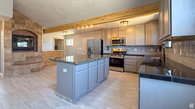 121 2nd W, East Carbon, UT 84520 - kitchen featuring appliances with stainless steel finishes, a center island, and decorative backsplash