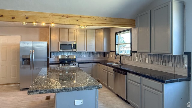 121 2nd W, East Carbon, UT 84520 - kitchen with appliances with stainless steel finishes, light wood-type flooring, decorative backsplash, beamed ceiling, and a kitchen island