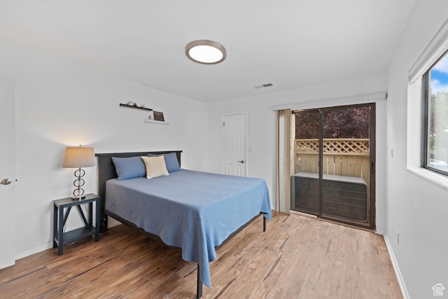 480 S 200 W Unit 6, St George, UT 84770 - bedroom featuring access to exterior, wood finished floors, and baseboards