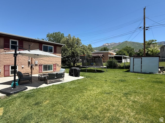 4350 S 850 E, South Ogden, UT 84403 - view of green lawn featuring a trampoline, a patio, a mountain view, and an outdoor hangout area
