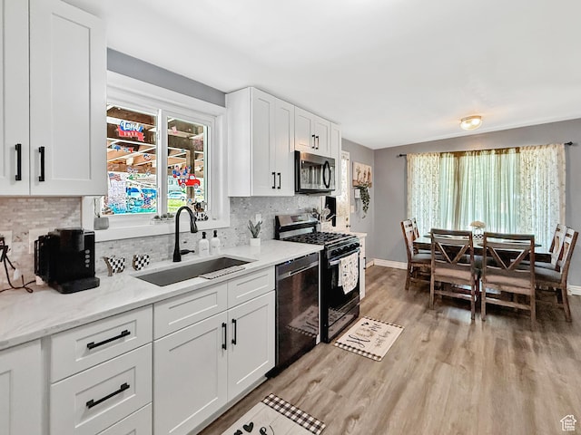 4350 S 850 E, South Ogden, UT 84403 - kitchen with stainless steel appliances, a sink, light wood-type flooring, and decorative backsplash