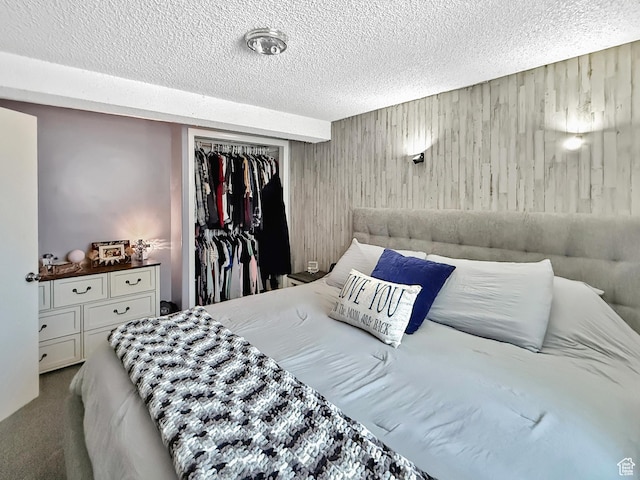 4350 S 850 E, South Ogden, UT 84403 - carpeted bedroom with a textured ceiling, wood walls, and a closet