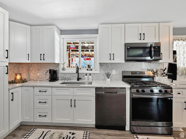 4350 S 850 E, South Ogden, UT 84403 - kitchen featuring appliances with stainless steel finishes, a sink, healthy amount of natural light, and white cabinets