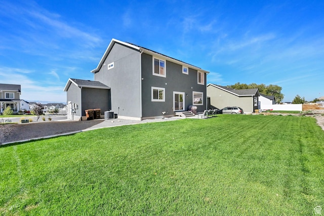 8498 N Colette St, Lake Point, UT 84074 - rear view of house with a yard, stucco siding, and central AC