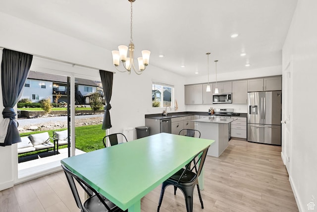 8498 N Colette St, Lake Point, UT 84074 - dining space featuring light wood-type flooring, recessed lighting, a chandelier, and baseboards