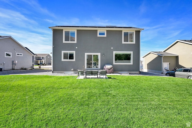 8498 N Colette St, Lake Point, UT 84074 - rear view of house featuring a yard, stucco siding, and solar panels