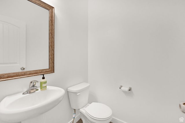 8498 N Colette St, Lake Point, UT 84074 - half bath featuring baseboards, a sink, and toilet