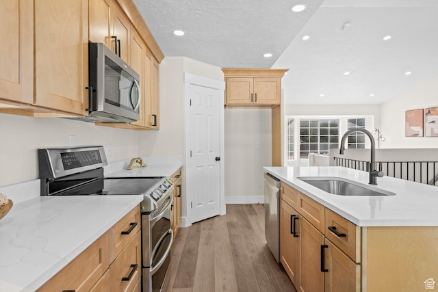 2139 N 300 W, Lehi, UT 84043 - kitchen with appliances with stainless steel finishes, a sink, wood finished floors, light brown cabinetry, and recessed lighting
