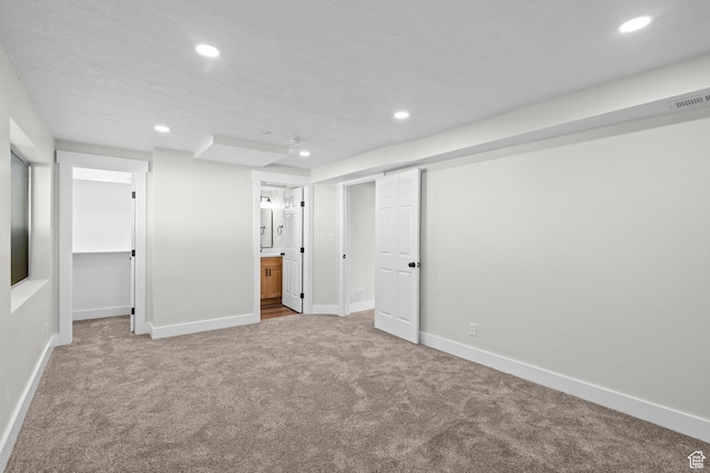 2139 N 300 W, Lehi, UT 84043 - unfurnished bedroom with carpet, recessed lighting, a walk in closet, baseboards, and connected bathroom