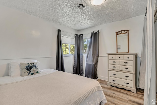 232 E 5900 S, Murray, UT 84107 - bedroom with a textured ceiling and light wood-style flooring