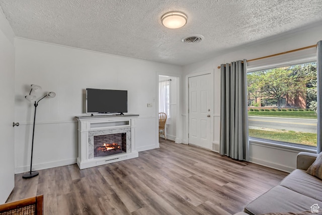 232 E 5900 S, Murray, UT 84107 - living area featuring a textured ceiling, wood finished floors, a premium fireplace, and baseboards