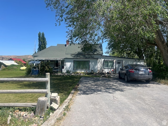 1157 E 3200 N, Preston, ID 83263 - view of front facade featuring a front yard, driveway, and a chimney