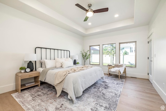 5865 Belmont Dr, Mountain Green, UT 84050 - bedroom with light wood-style flooring, baseboards, recessed lighting, a raised ceiling, and a ceiling fan