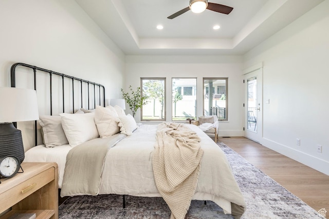 5865 Belmont Dr, Mountain Green, UT 84050 - bedroom with wood finished floors, a tray ceiling, baseboards, recessed lighting, and a ceiling fan