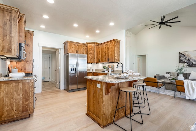 5865 Belmont Dr, Mountain Green, UT 84050 - kitchen featuring appliances with stainless steel finishes, a peninsula, light wood finished floors, open floor plan, and recessed lighting