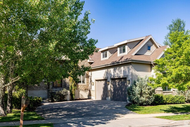 5865 Belmont Dr, Mountain Green, UT 84050 - view of front of home with stone siding, concrete driveway, roof with shingles, and a garage