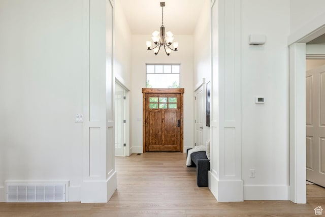 5865 Belmont Dr, Mountain Green, UT 84050 - entrance foyer with a chandelier, light wood-style floors, and baseboards