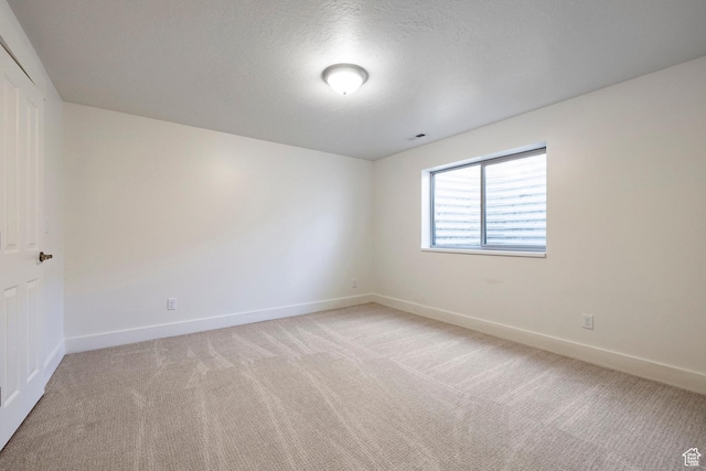 5865 Belmont Dr, Mountain Green, UT 84050 - spare room featuring light colored carpet, baseboards, and a textured ceiling