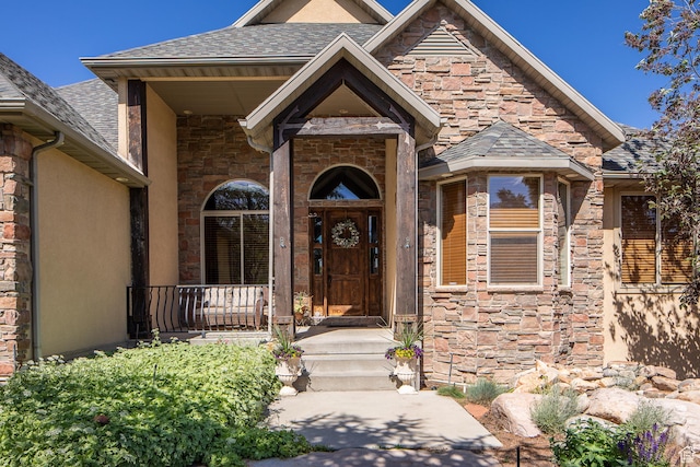 13966 S Arrow Creek Dr E, Draper, UT 84020 - doorway to property with stone siding, a shingled roof, and stucco siding