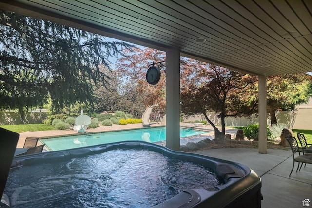 13966 S Arrow Creek Dr E, Draper, UT 84020 - view of swimming pool featuring a hot tub, a water slide, a fenced backyard, and a patio area