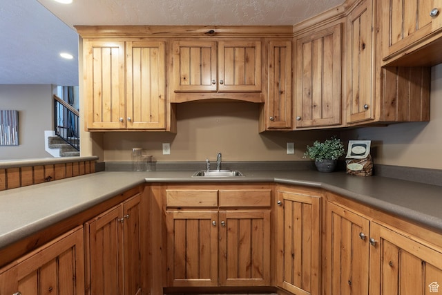 13966 S Arrow Creek Dr E, Draper, UT 84020 - kitchen featuring a sink, recessed lighting, brown cabinetry, and light countertops