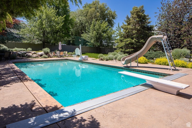 13966 S Arrow Creek Dr E, Draper, UT 84020 - view of swimming pool with a water slide, a diving board, a fenced backyard, and a patio area