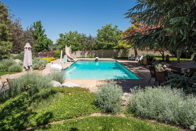 13966 S Arrow Creek Dr E, Draper, UT 84020 - view of pool with a water slide, a patio area, and a diving board