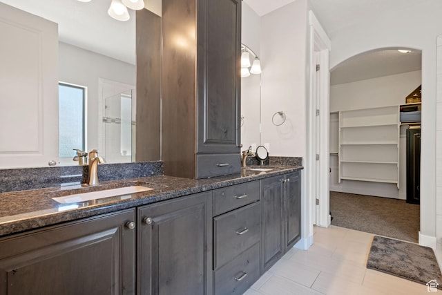 14982 S Aurora Vista Dr W, Herriman, UT 84096 - full bath with double vanity, a walk in closet, and a stall shower