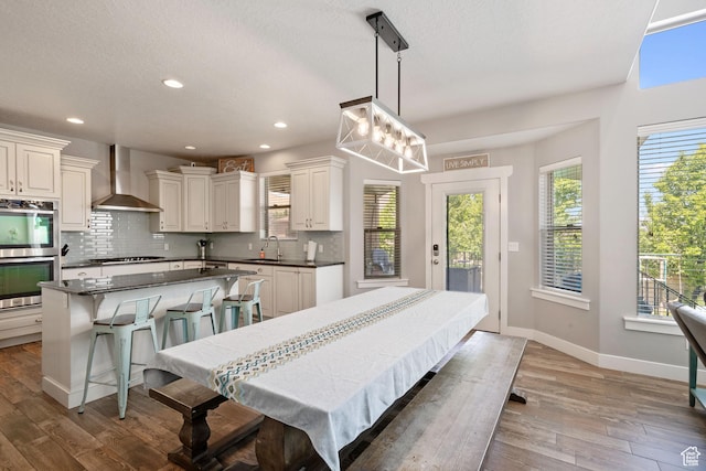 14982 S Aurora Vista Dr W, Herriman, UT 84096 - dining area featuring wood finished floors, baseboards, recessed lighting, and a textured ceiling