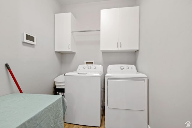 14982 S Aurora Vista Dr W, Herriman, UT 84096 - laundry area featuring cabinet space, washing machine and clothes dryer, and light wood-style flooring