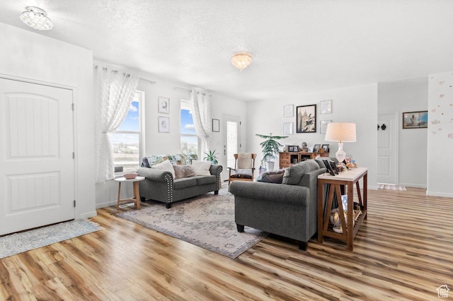 687 E 200 S, Spring City, UT 84662 - living room featuring wood finished floors, baseboards, and a textured ceiling