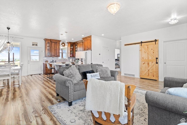 687 E 200 S, Spring City, UT 84662 - living area featuring light wood-style floors, a barn door, recessed lighting, and a chandelier