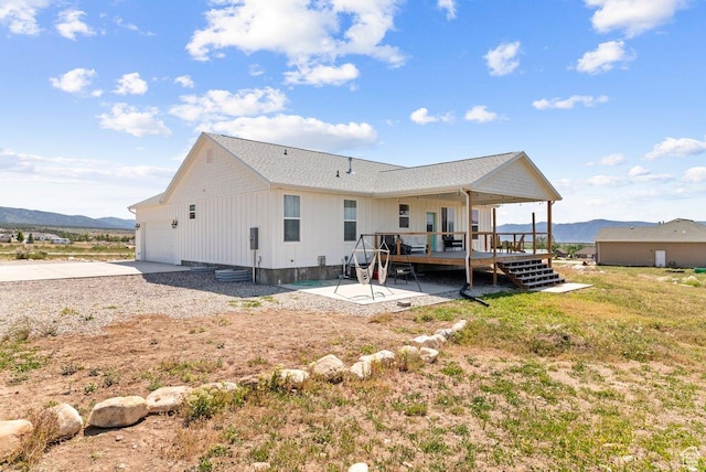 687 E 200 S, Spring City, UT 84662 - rear view of house featuring a deck with mountain view, a garage, concrete driveway, board and batten siding, and a patio area