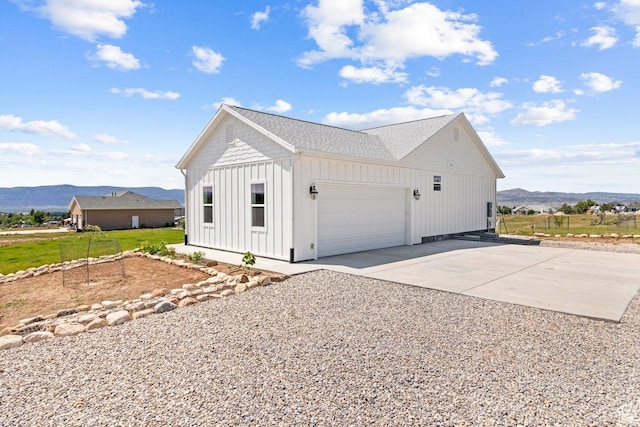 687 E 200 S, Spring City, UT 84662 - view of home's exterior with a mountain view, board and batten siding, a garage, and concrete driveway