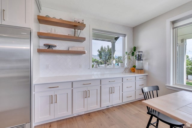 1485 W 1930 N, Pleasant Grove, UT 84062 - kitchen with stainless steel refrigerator, decorative backsplash, healthy amount of natural light, and light wood-style floors