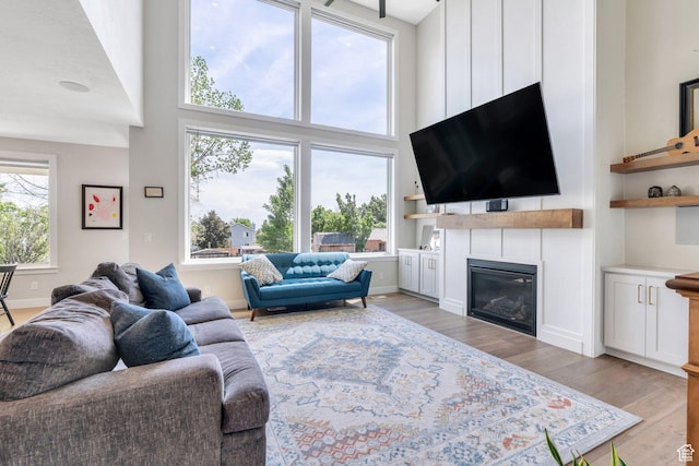 1485 W 1930 N, Pleasant Grove, UT 84062 - living area featuring a high ceiling, light wood-style flooring, and a glass covered fireplace
