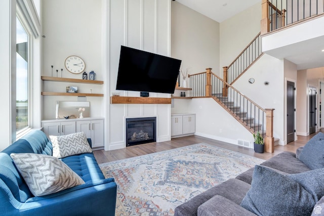 1485 W 1930 N, Pleasant Grove, UT 84062 - living area with stairs, wood finished floors, a high ceiling, and a large fireplace
