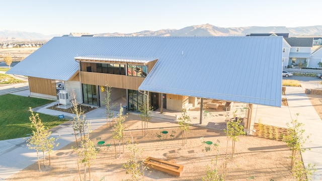 11436 S Watercourse Rd, South Jordan, UT 84009 - view of front of house with metal roof, a mountain view, a patio area, and cooling unit